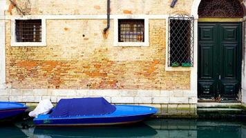 canal and boats with ancient buildings background photo