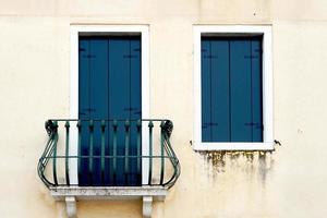 door with balcony and window on creme wall photo