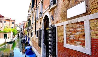 canal and boats with ancient buildings horizontal photo