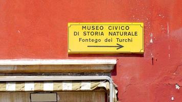 red color wall with sign photo