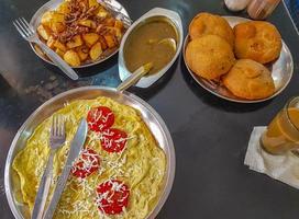Typical indian food with fried potatoes aloo puri curry India. photo