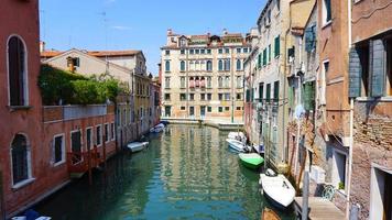 canal and boats with ancient buildings photo