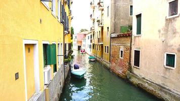 canal and boats with ancient architecture in Venice, Italy photo