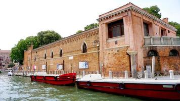 canal and boats with ancient architecture photo