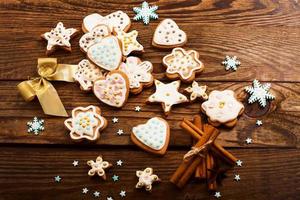 Frame of christmas sweet cookies on dark brown wooden background. Top view and copy space. Mock up. Happy new year concept photo