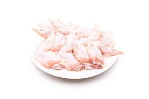 Raw chicken wing in white dish isolated on white photo