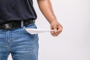 No money in pants pocket. Close up man holding his empty pants pocket to show no money inside. Financial concept photo