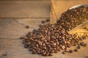 Coffee bean on wooden table background. Food and beverage concept photo