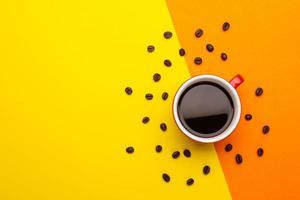 Top view black coffee or Americano in red cup isolated on yellow photo