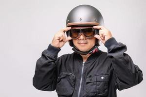 motociclista o jinete con casco antiguo. concepto de campaña de viaje seguro. tiro del estudio aislado en gris foto