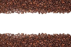 Roasted coffee beans. Top view brown coffee beans texture isolated on white photo