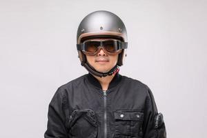 Motorcyclist or rider wearing vintage helmet. Safe ride concept. Studio shot on grey photo