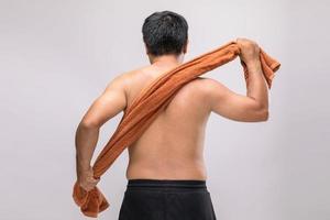 Close up man holding towel to rub the body dry after shower. To used wet towel can be the dermatitis on the body concept photo