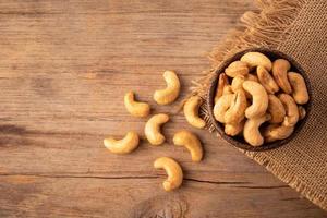 Pile of roasted cashew nut in bowl on the table background. Food concept photo