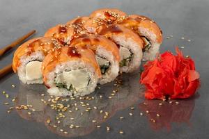 Sushi sets Uramaki, California, Philadelphia, rolls on a white plate. Menu for restaurants, cafes. On a dark reflective background. photo