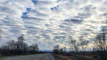 Blue sky with clouds. Road, exit from the occupied territories. War in Ukraine. Escape from the aggressor. photo