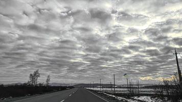 Blue sky with clouds. Road, exit from the occupied territories. War in Ukraine. Escape from the aggressor. photo