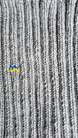 Handmade balaclava with Ukrainian symbols. Knitted from gray and green threads. Warms, reliably saves from the cold. photo
