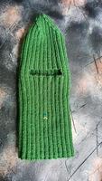 Handmade balaclava with Ukrainian symbols. Knitted from gray and green threads. Warms, reliably saves from the cold. photo