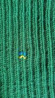 Handmade balaclava with Ukrainian symbols. Knitted from gray and green threads. Warms, reliably saves from the cold. photo