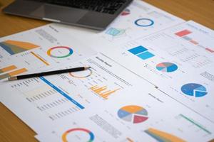 Marketing, Finance, Accounting, Planning, Analyze company results and profits with statistical graphs. Use a laptop computer and a calculator to calculate your company balance. photo