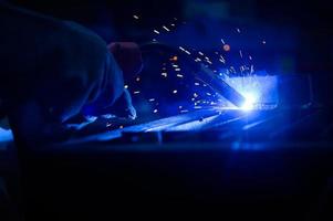 A welder is working to weld metal. to create quality work according to the prescribed form photo