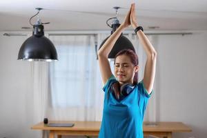 Relieve stress, relax muscles, practice breathing, exercise, meditation. Woman practicing yoga and muscles at home on vacation. photo