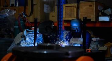 A welder is working to weld metal. to create quality work according to the prescribed form photo