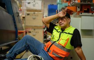 Factory worker Working hard until the symptoms of congenital disease exacerbate photo