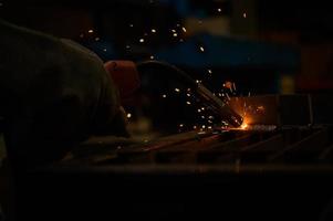 A welder is working to weld metal. to create quality work according to the prescribed form photo