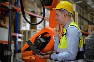 A male engineer checking the operation of a welding robot. used for precision welding control Fast and highly secure photo