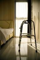 A bedroom showing the golden morning sun shining through the curtains. through the window into the room of the elderly who had to use a walking stick photo