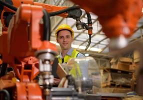 A male engineer checking the operation of a welding robot. used for precision welding control Fast and highly secure photo