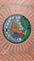 Bangkok, Thailand - January 27, 2020 - Manhole cover on floor at riverside near Sampeng photo