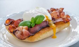 Sandwich with poached egg and bacon photo
