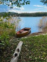 boat on the shore of the autumn lake photo