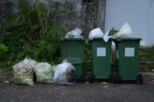 Garbage in plastic bags in trash bins photo