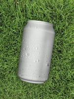 Top view. of Aluminum can with water droplets on grass green photo