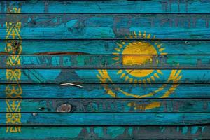 The national flag of Kazakhstan  is painted on uneven boards. Country symbol. photo
