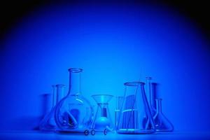 3D  illustration laboratory glass equipment, test tubes and flasks on blue background. Laboratory glassware for medical or scientific research. Empty flasks, glasses. photo