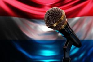 Microphone on the background of the National Flag of Luxembourg, realistic 3d illustration. music award, karaoke, radio and recording studio sound equipment photo