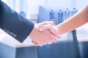 Business partner or coorperation concept. Closed up business man and woman shaking hands after finished meeting up. Successful business  negotiating photo