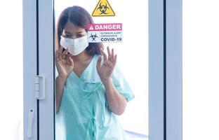 COVID-19, Corona Virus outbreak, quarantine and epidemic spread concept. Asian depressed CORONA or COVID-19 patient infection wear face mask in quarantine room at the hospital photo