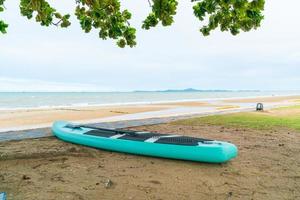 paddle board on beach with sea background photo