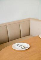 empty white plate on dinning table photo