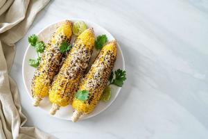 barbecue and grilled corn with cheese and lime photo