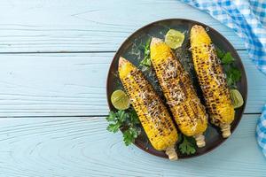 barbecue and grilled corn with cheese and lime