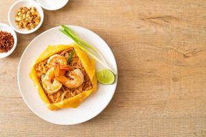 Thai stir fried noodles with shrimps and egg wrap or Pad Thai photo