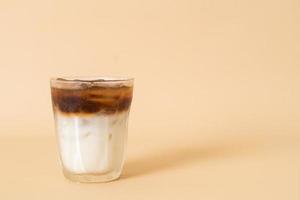 iced coffee with milk layer in glass photo