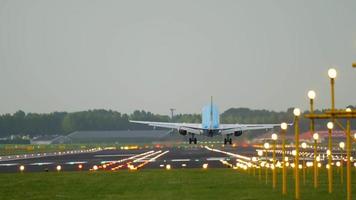 AMSTERDAM, THE NETHERLANDS JULY 27, 2017 - KLM Boeing 737 airliner landing on the runway in a crosswind with it's fuselage slightly skewed. View from the edge of the runway behind ALS masts video